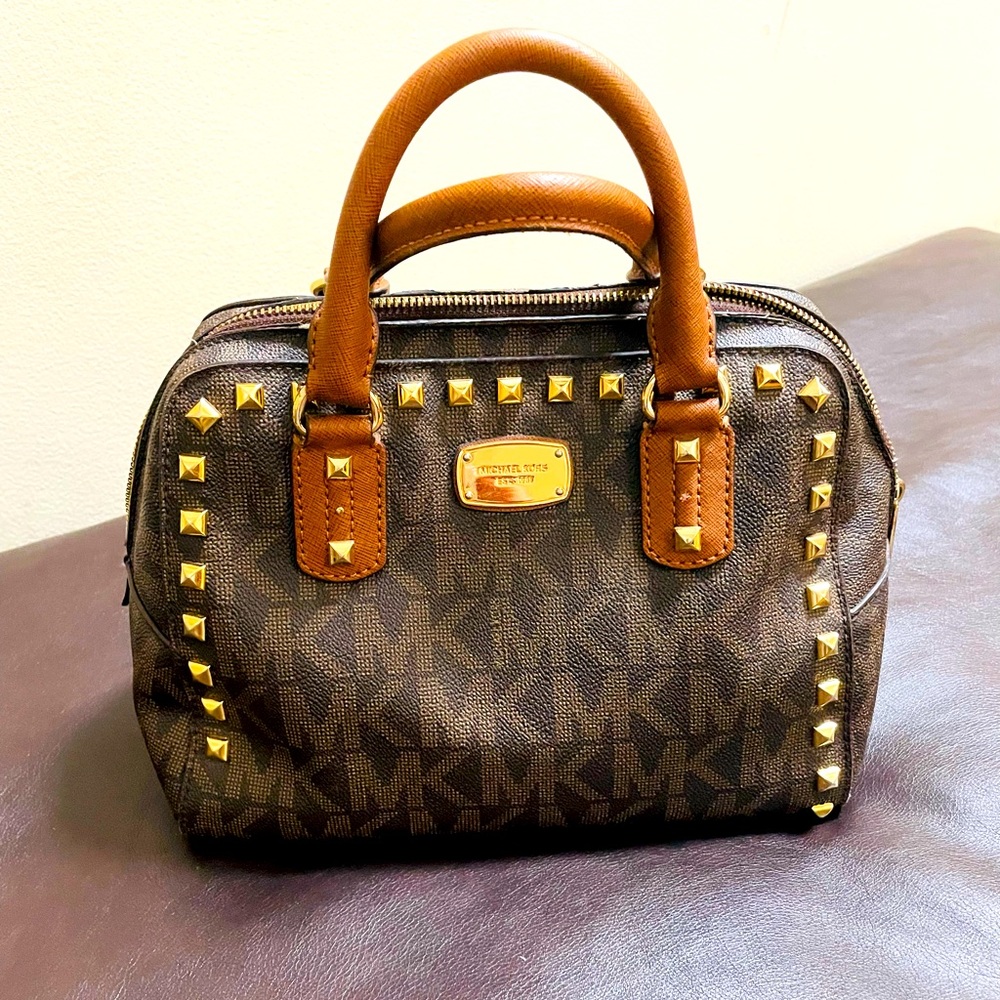 MK handbag with strap for shoulder wear.